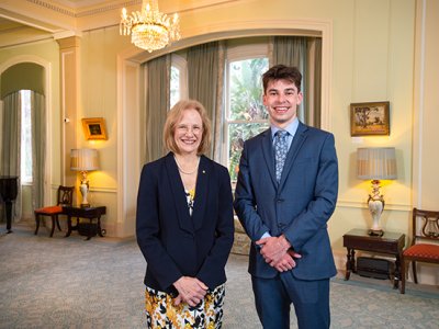 A woman and a man standing side-by-side smiling